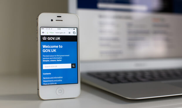 An iPhone displaying the GOV.UK homepage.