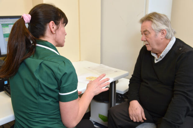 A man having an Abdominal Aortic Aneurysm Screening consultation