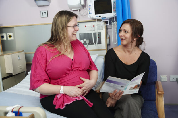 A pregnant woman with a midwife.