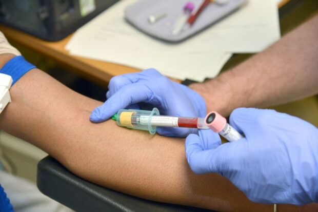 A sample of blood being taken from someone's arm