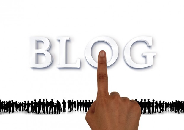 A finger points to the word blog