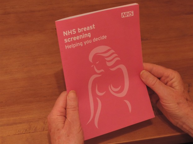 Photo of breast screening leaflet with hands.