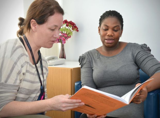 A health professional talking to a woman.