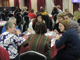 Conference delegates sitting around a table.