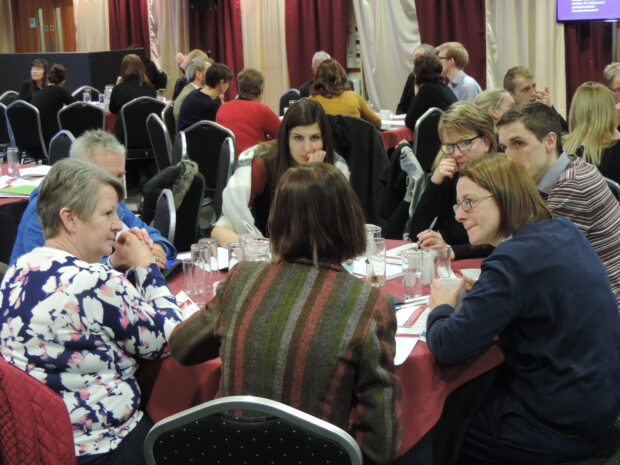 A group of stakeholders discussing screening at the annual conference