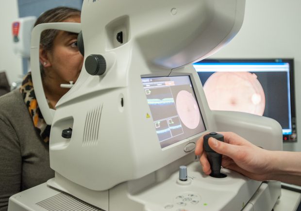 A woman having a diabetic eye screening test taken