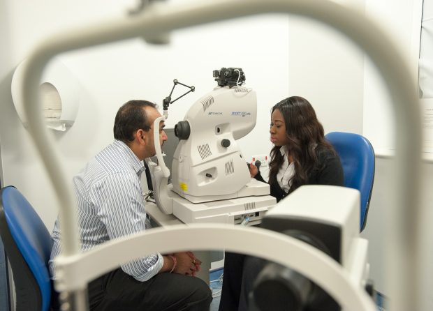 A man having an eye screening test taken.