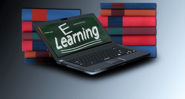 A laptop with the word 'e-learning' on screen, and some books.