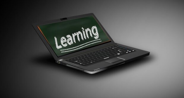 A laptop with the word 'Learning' written on screen.