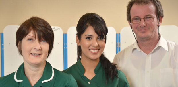 2 women and 1 man in a healthcare setting.