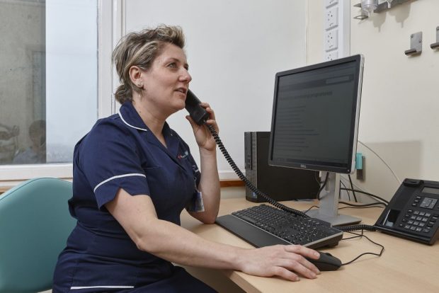 Health worker at desk and computer screen