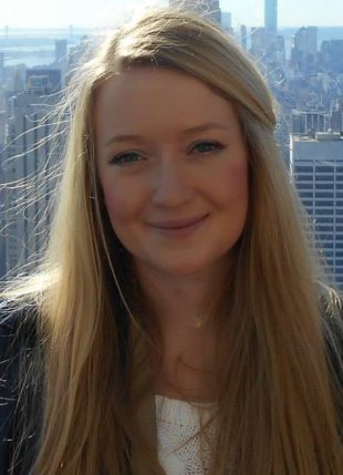 Rachel Crowther with a city landscape behind her.