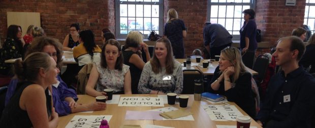 Delegates sit round a table and share learning at the away day in Preston.