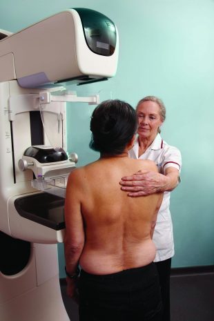 A woman is having a mammogram.