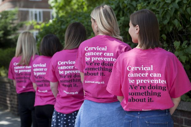 Five women with their back to the camera with pink t shirts. The words 'cervical cancer can be prevented. We're doing something about it' can be seen.
