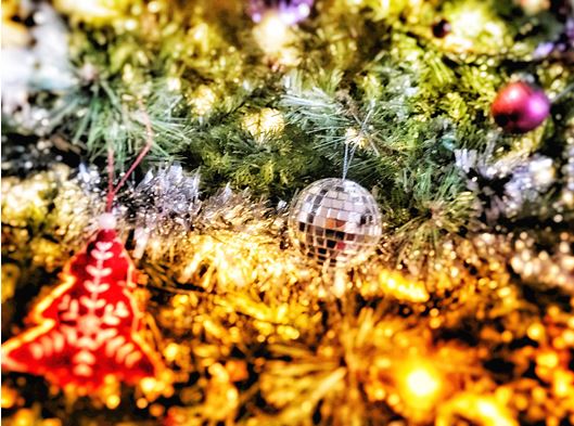 A photo of a Christmas tree with bright festive decorations