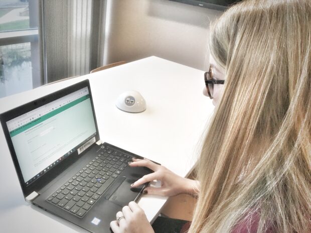 Woman using the old extranet on a laptop computer.