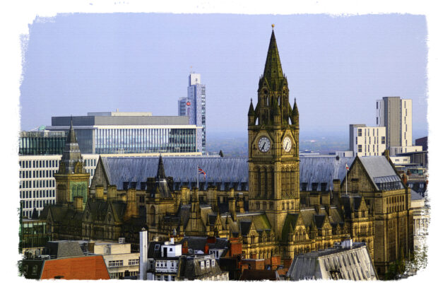 A photo of the skyline of Manchester showing the town hall and other buildings