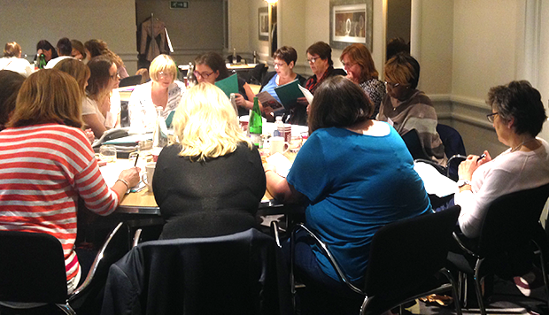 Attendees in discussion at tables at one of the workshops run by the national data team