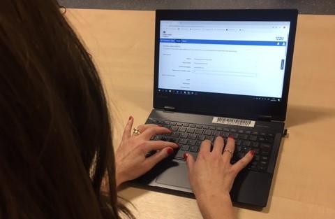 Woman typing on a laptop