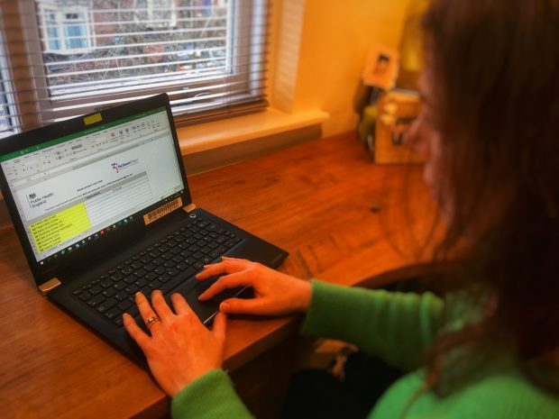 Woman filling in a Sloane Project form on a laptop computer.