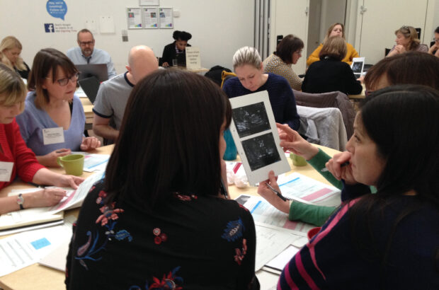 Sonographers sat in groups around tables during the group work sessions of the national meeting