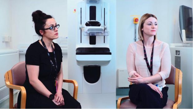 Health improvement practitioners Gina Newman, left, and Jessica Mulroy Johnson sitting in a clinic room