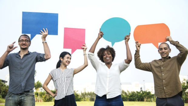 4 people hold up speech signs