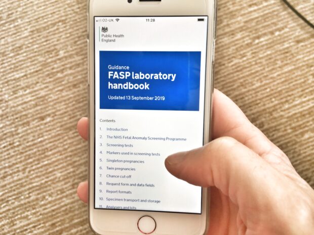 Mobile phone shows the new handbook online with the words 'FASP lab handbook' as the main heading.