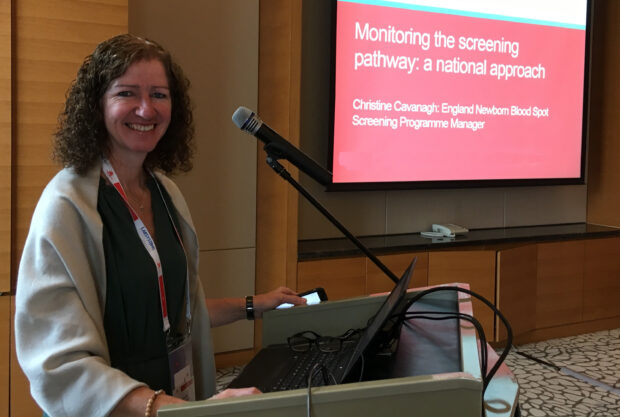 Christine Cavanagh stood at a lectern presenting at the 2019 ISNS conference in China.