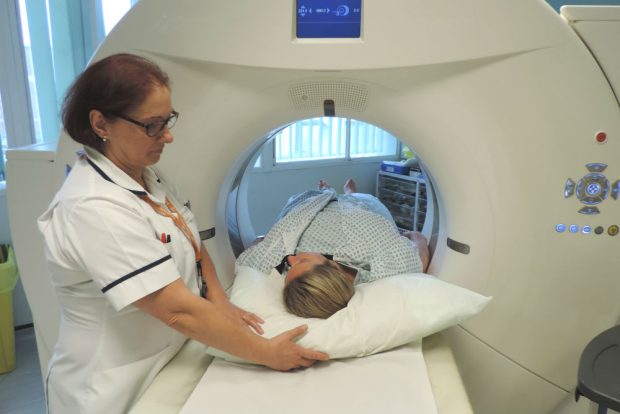 A health professional about to start a bowel scan on a patient