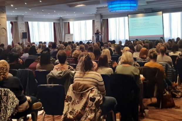 A crowd of attendees listen to a speaker at the newborn and infant physical examination conference in Manchester in September