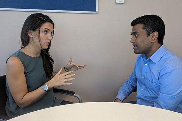 Two people are having a difficult conversation. One of them looks unhappy with the other.