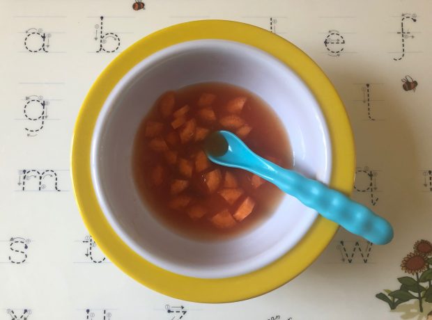 A bowl of chopped carrots in tomato sauce