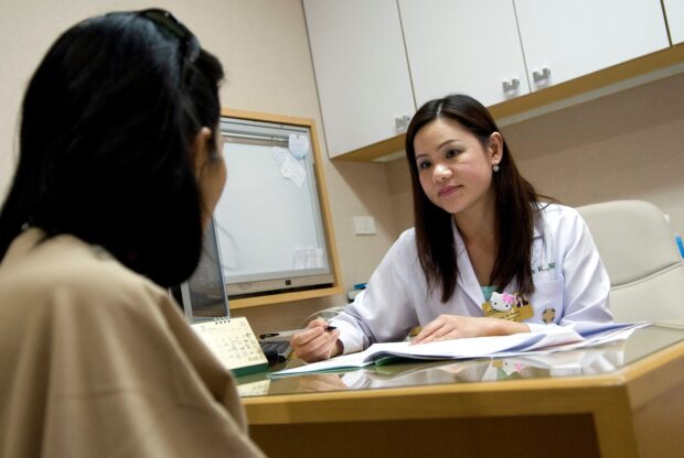 A female doctor talking to a patient