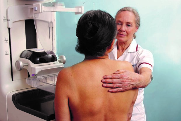 A woman having a mammogram screen taken by another woman