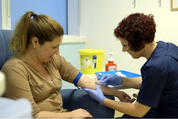 Bloods are taken from a woman's arm.