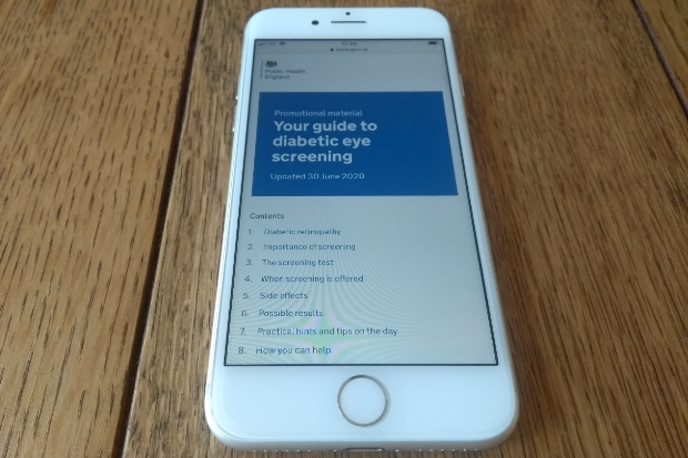 A mobile phone showing the digital version of 'Your guide to diabetic eye screening'.