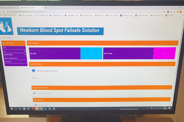 A desktop computer with the newborn blood spot failsafe solution IT system displayed on the screen.